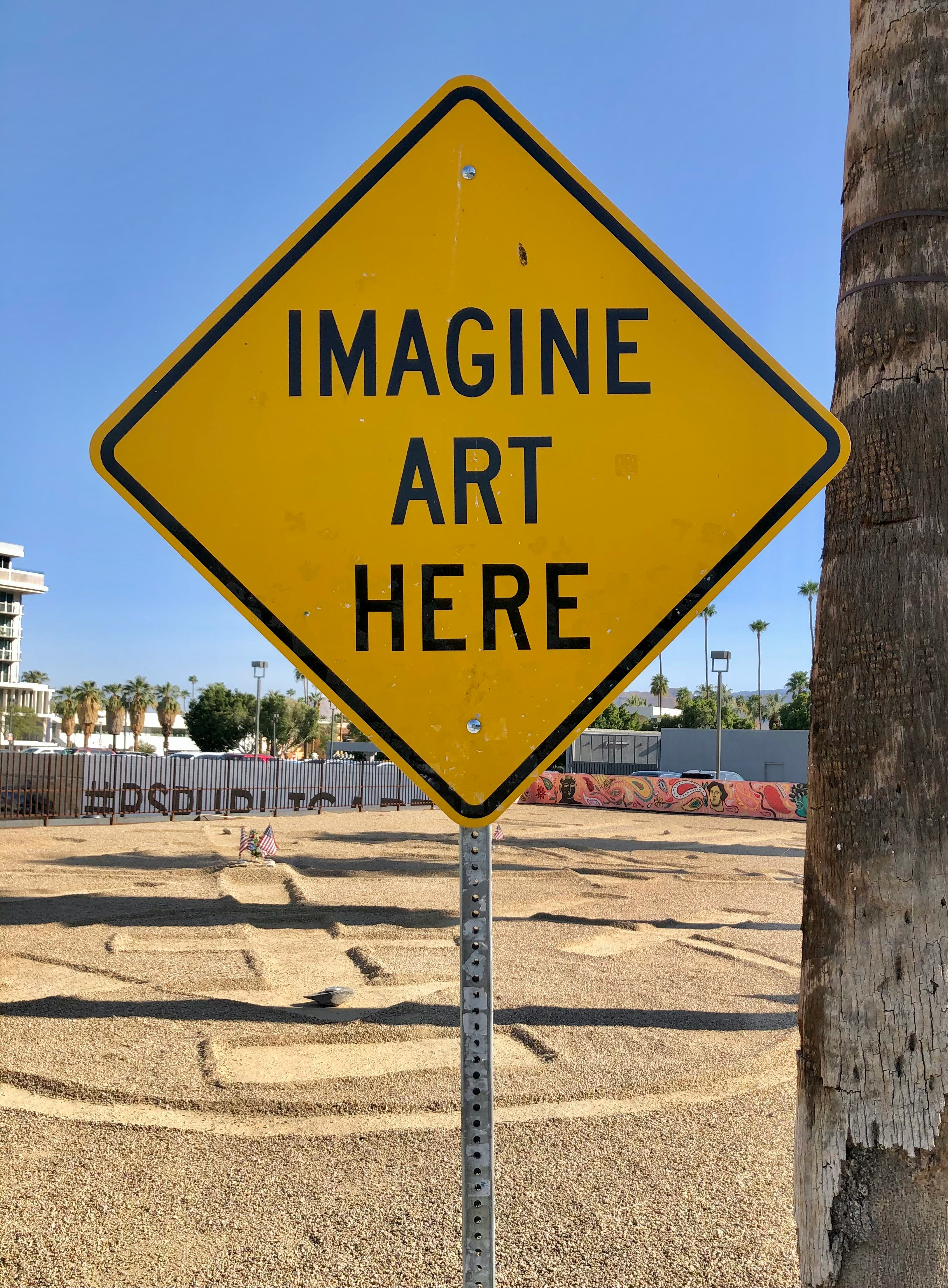 A yellow sign that says imagine art here